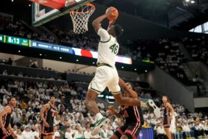 James Nnaji #46 of the Baylor Bears goes up to dunk over Joseph Tugler #11 of the Houston Cougars.