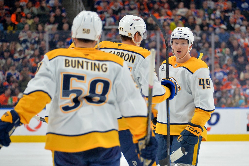 Michael Bunting #58, Michael McCarron #47 and Reid Schaefer #49 of the Nashville Predators celebrate a third-period goal against the Edmonton Oilers.