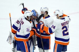 Members of the New York Islanders celebrate the win against the Minnesota Wild.