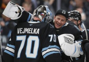 Vitek Vanecek #41 of the Utah Mammoth congratulates Karel Vejmelka #70 after their win against the Toronto Maple Leafs.