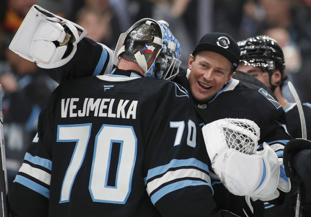 Vitek Vanecek #41 of the Utah Mammoth congratulates Karel Vejmelka #70 after their win against the Toronto Maple Leafs.