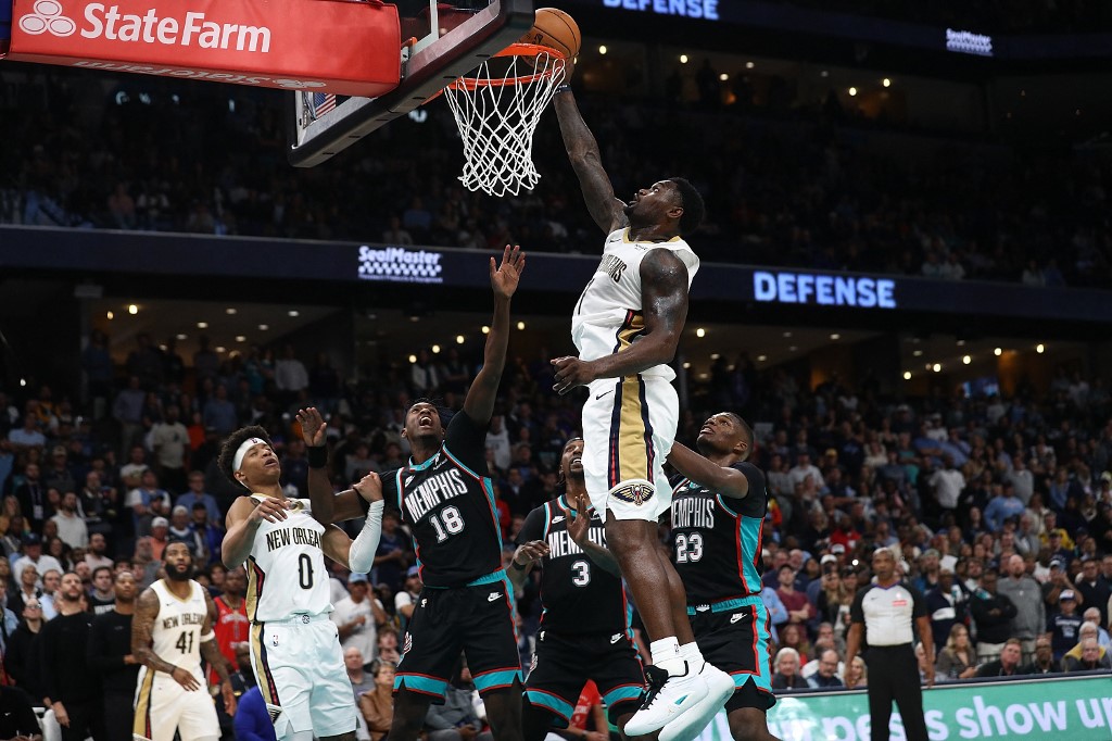 Zion Williamson #1 of the New Orleans Pelicans goes to the basket against Olivier-Maxence Prosper #18 of the Memphis Grizzlies.