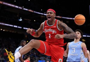 The cover for this college basketball picks today article shows Amare Bynum #1 of the Ohio State Buckeyes reacting during the first half of the game between the North Carolina Tar Heels and Ohio State Buckeyes.