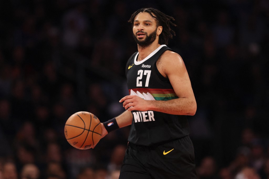 The cover for this NBA player props today article shows Jamal Murray #27 of the Denver Nuggets dribbling the ball during the first quarter against the New York Knicks.
