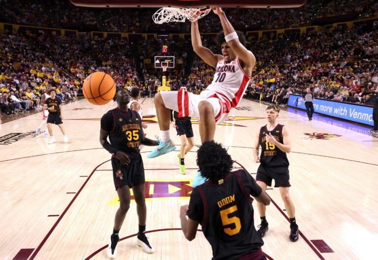 The cover for this college basketball picks today article shows Koa Peat #10 of the Arizona Wildcats reacting after dunking the ball against the Arizona State Sun Devils during the second half.