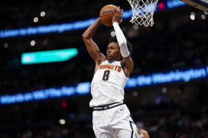 Peyton Watson #8 of the Denver Nuggets grabs a rebound against the Washington Wizards.