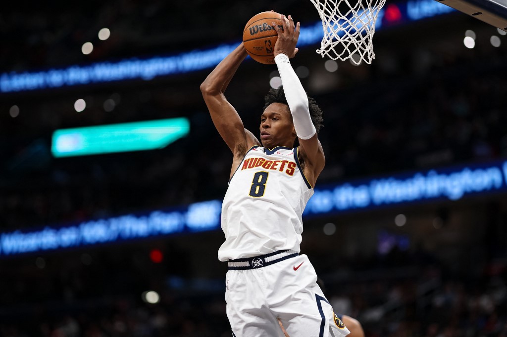 Peyton Watson #8 of the Denver Nuggets grabs a rebound against the Washington Wizards.