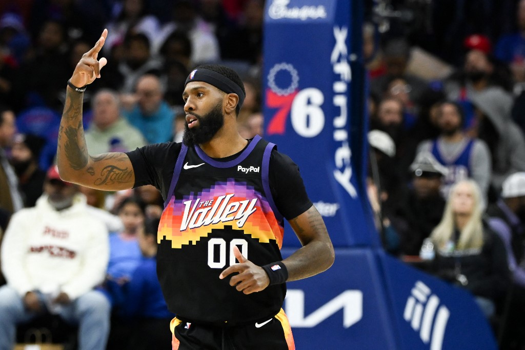 The cover for this NBA player props today article shows Royce O'Neale #00 of the Phoenix Suns celebrating scoring a three-pointer during the second half.