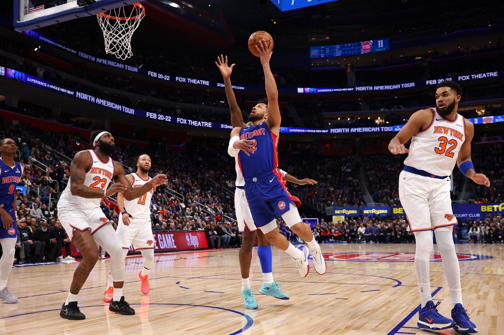 Cade Cunningham #2 of the Detroit Pistons drives to the basket against OG Anunoby #8 of the New York Knicks.