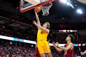 Grayson Grove #2 of the Minnesota Golden Gophers scores past Hayden Jones #13 of the Wisconsin Badgers.