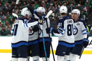 Cole Perfetti #91 of the Winnipeg Jets is congratulated by Mark Scheifele #55 after scoring a goal against the Dallas Stars.