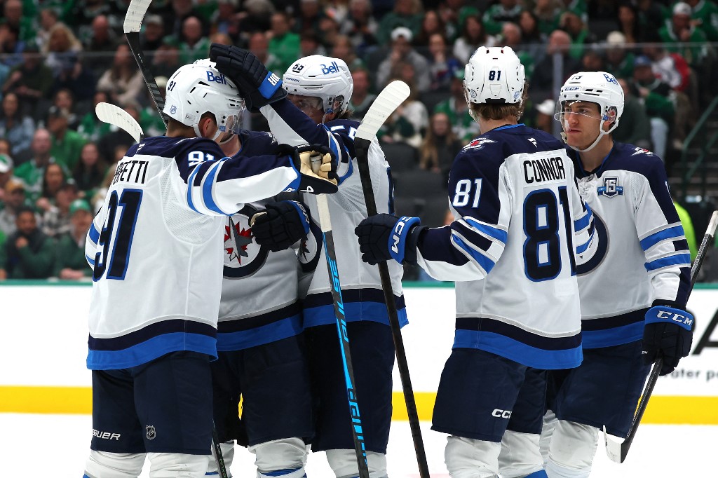 Cole Perfetti #91 of the Winnipeg Jets is congratulated by Mark Scheifele #55 after scoring a goal against the Dallas Stars.