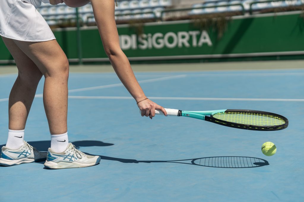 Photo by Ahmed ؜: https://www.pexels.com/photo/legs-and-arm-of-woman-playing-tennis-23340244/